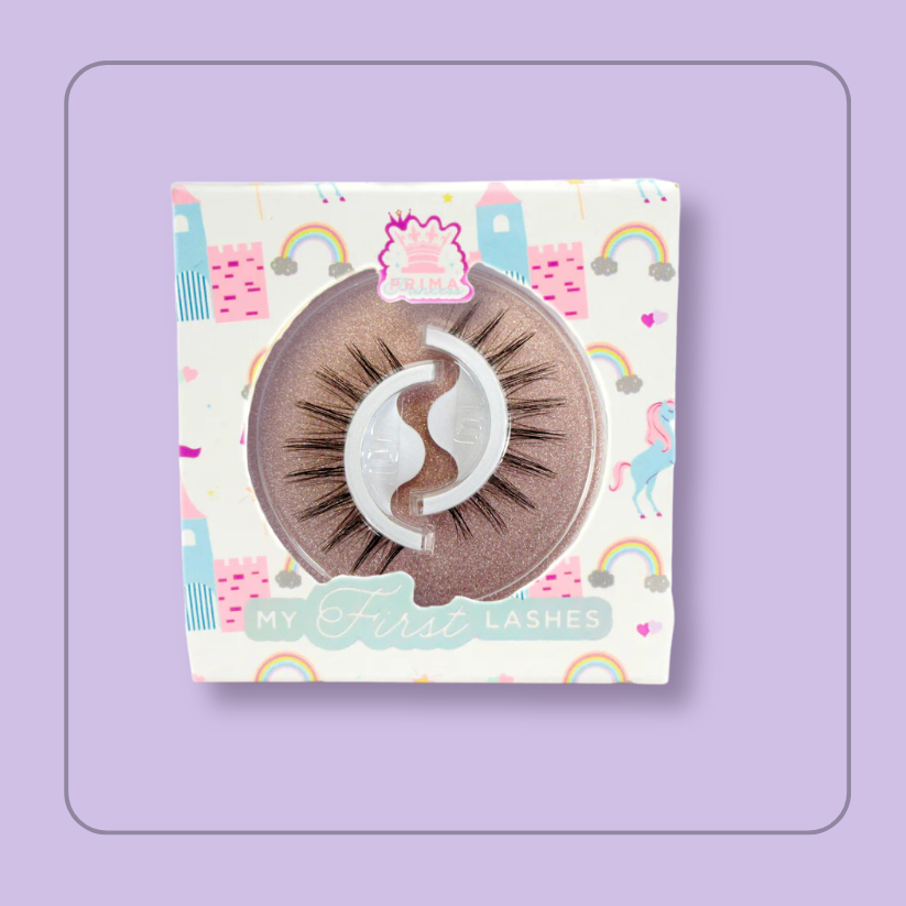 Packaging of 'My First Lashes - Cola Cube' with a clear window showing the self-adhesive lashes inside, surrounded by a colorful pattern with rainbow and unicorn illustrations.