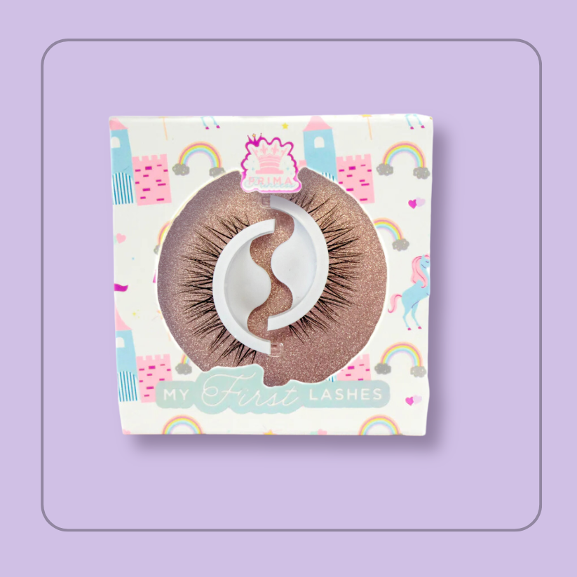 Packaging of 'My First Lashes' with a unicorn and rainbow and castle theme, featuring a pair of self-adhesive brown lashes visible through a clear plastic window. style Cupcake