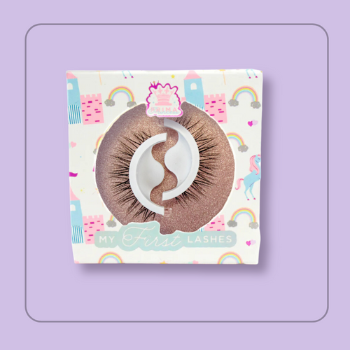 Packaging of 'My First Lashes' with a unicorn and rainbow and castle theme, featuring a pair of self-adhesive brown lashes visible through a clear plastic window. style Cupcake